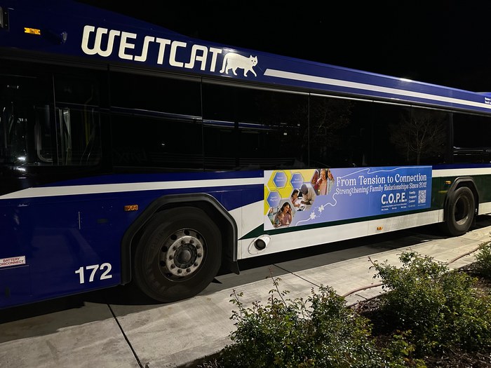The C.O.P.E. transit banner installed on the side of a WestCAT bus